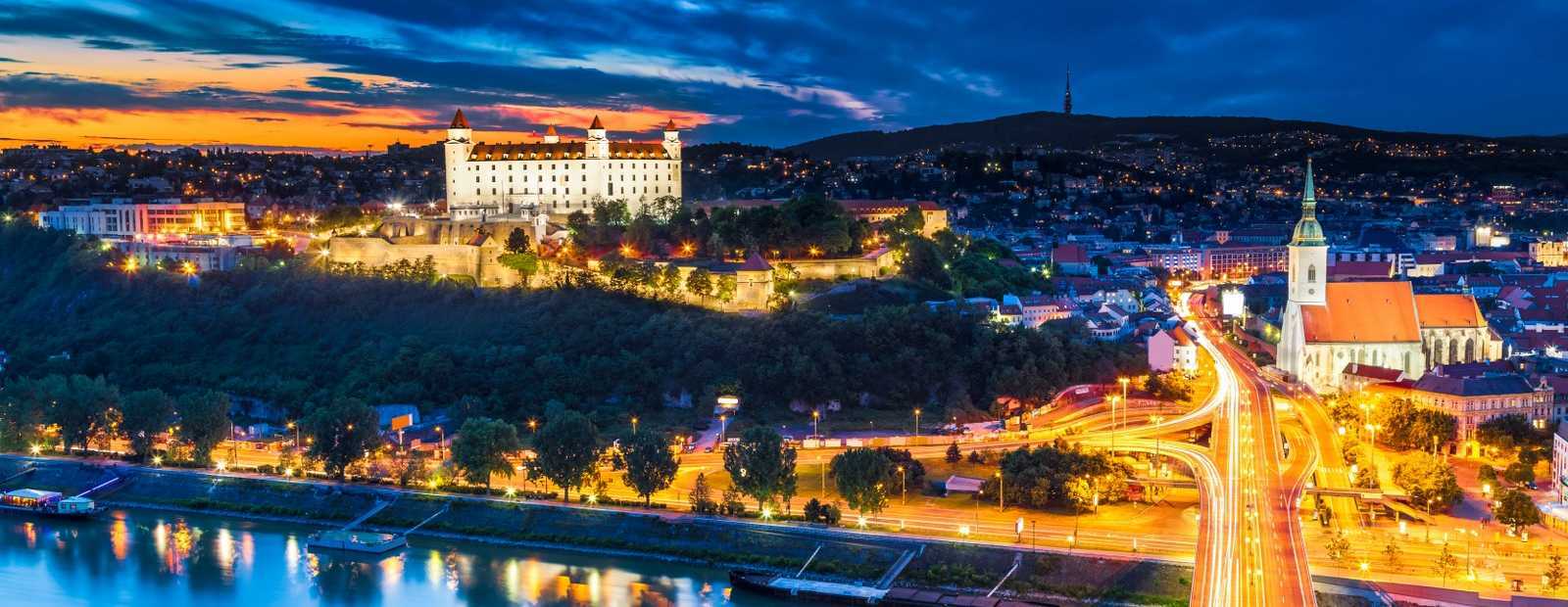 Bratislava city skyline with illuminated castle at night – top destination for a stag weekend in Bratislava”